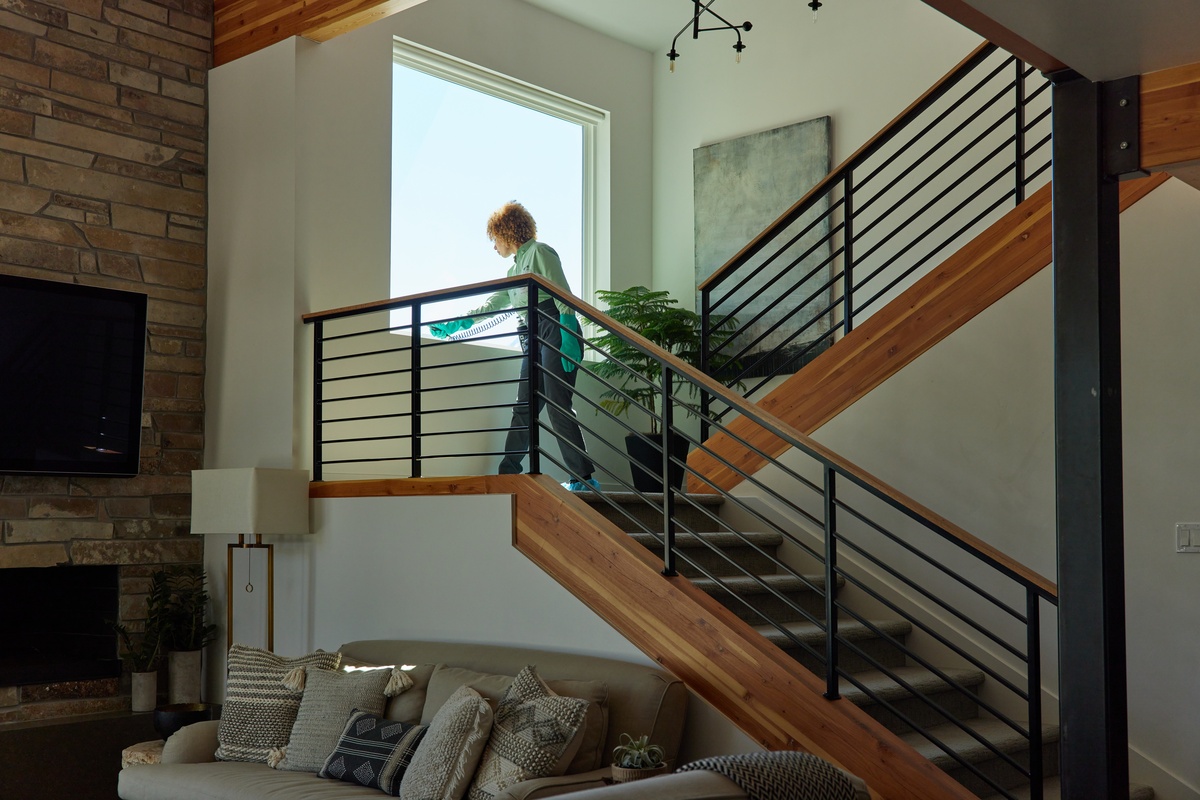 Service pro on interior stairs spraying window base