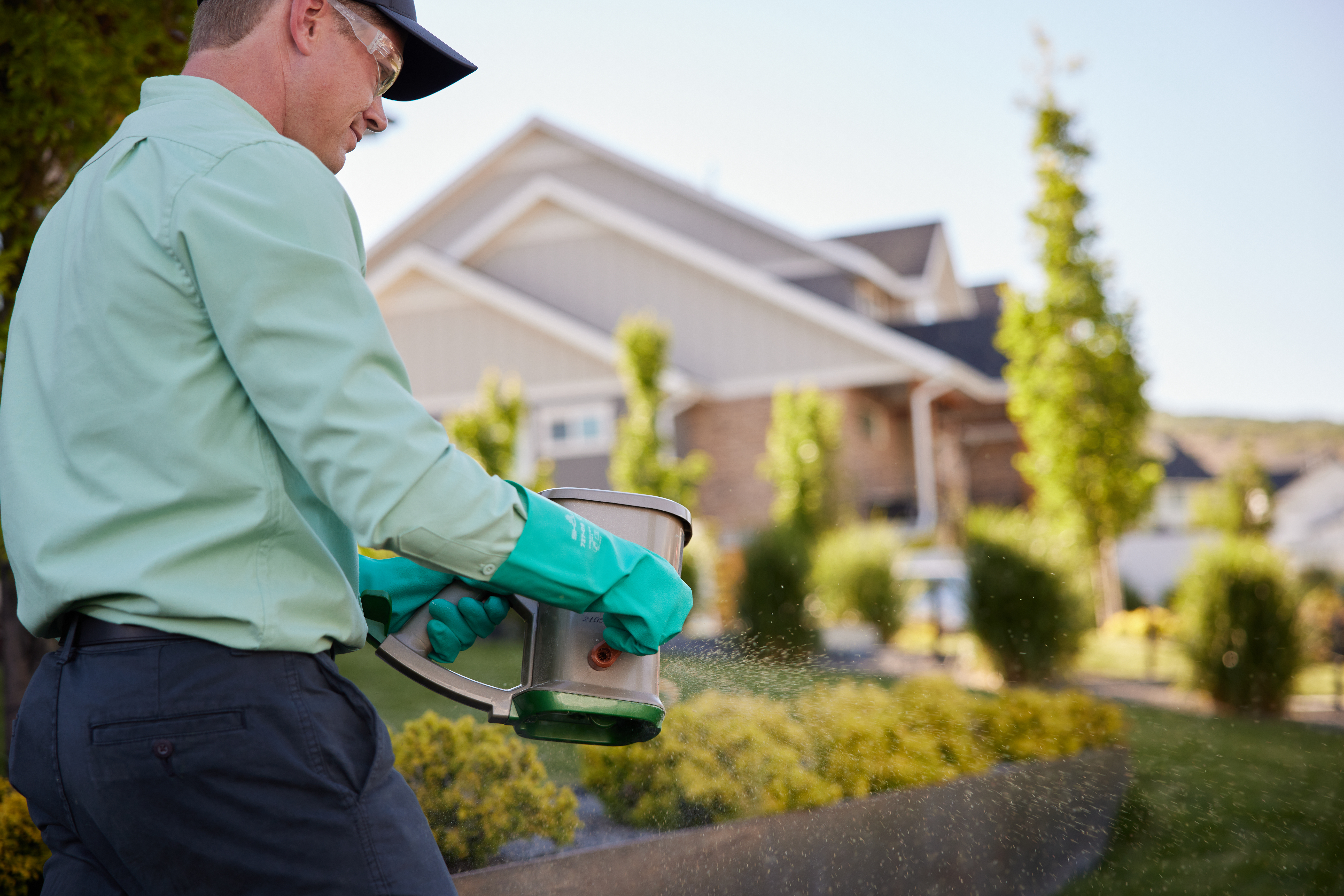 Service pro spraying treatment in customer's flowerbed